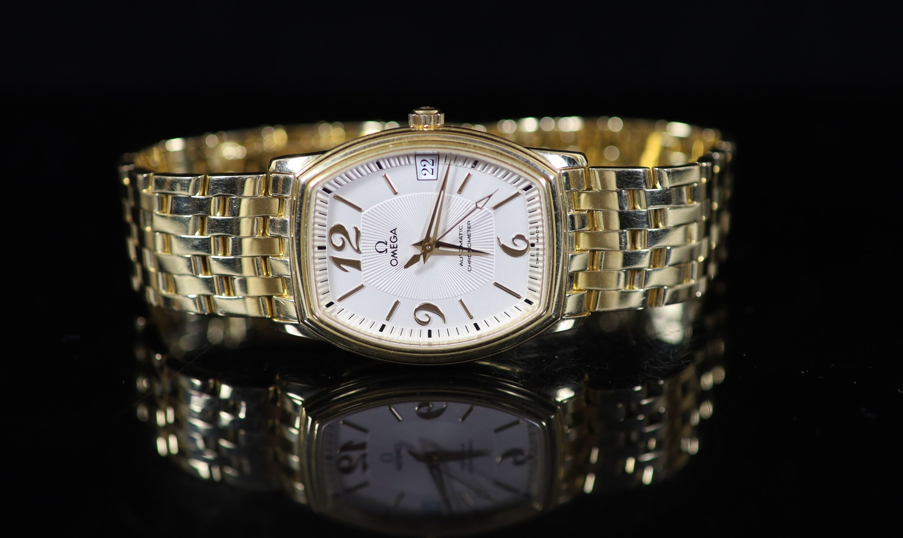 A gentleman's 18ct gold Omega Automatic Chronograph wrist watch, on an 18ct gold Omega bracelet